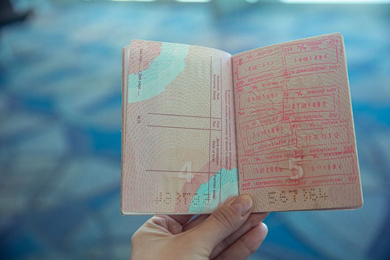 Close-up of an open passport showing approved travel stamps