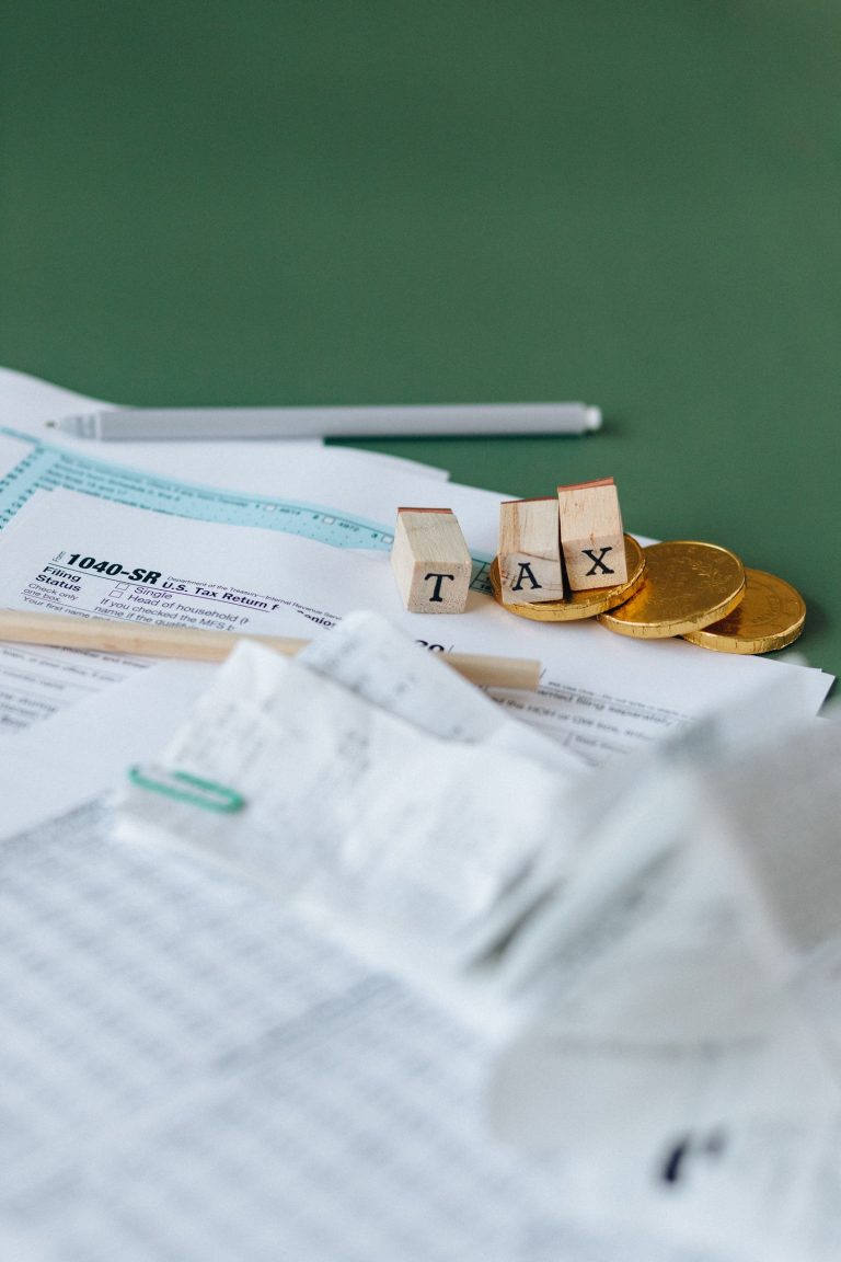 Tax forms and coins symbolizing visa application cost