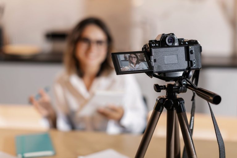 Woman vlogger using camera and tripod to create content