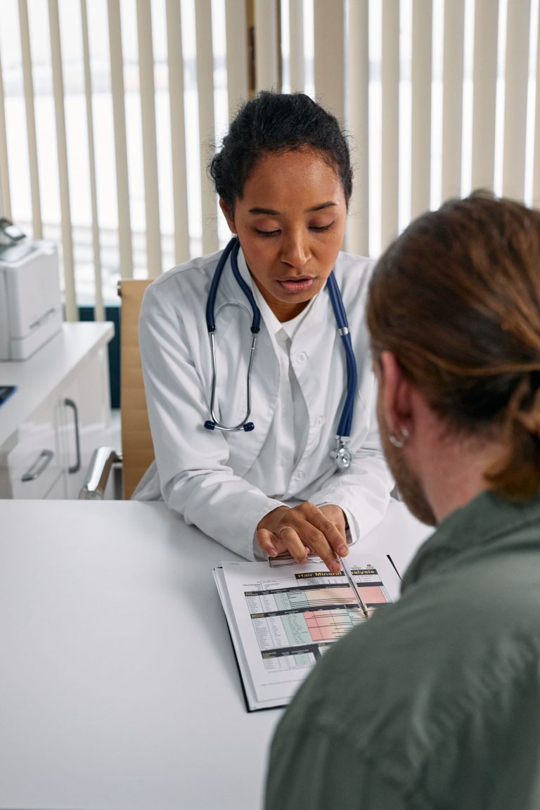 Female doctor discussing health chart with a patient during consultation