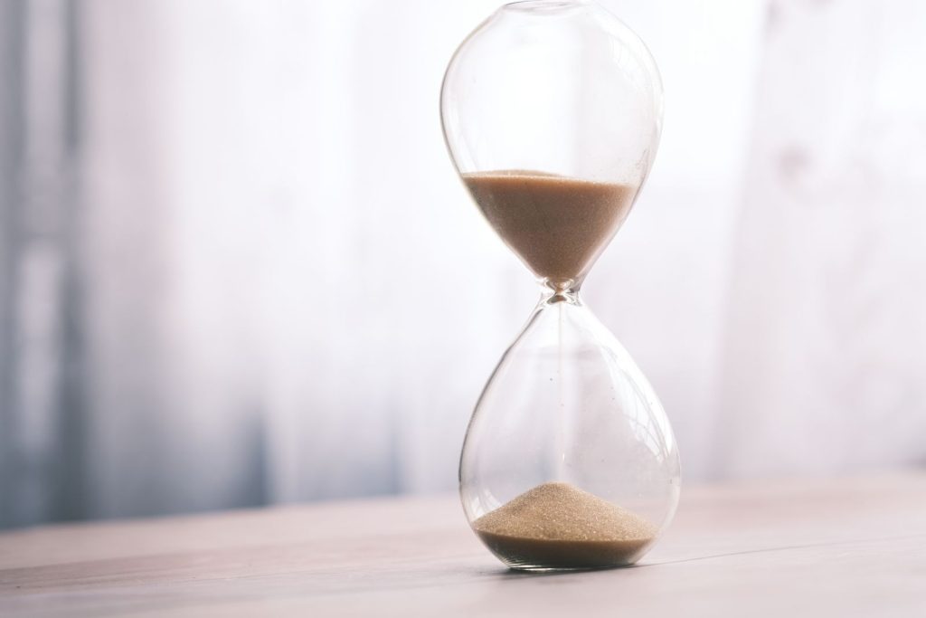 Hourglass with falling sand symbolizing visa processing wait time